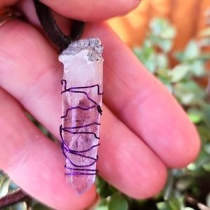 Amethyst crystal raw stone pendant wrapped with purple wire. Handmade